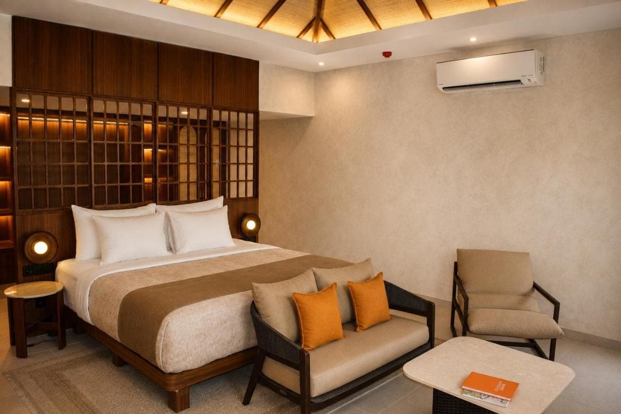 a hotel room with a bed and a chair at AlamKulkul Boutique Resort in Kuta