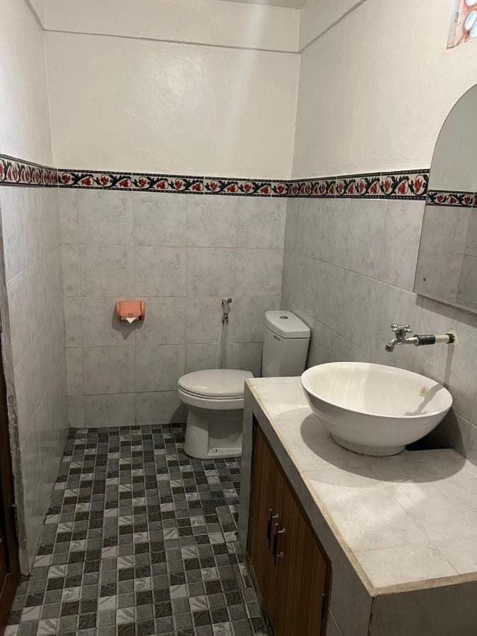 a bathroom with a sink and a toilet at Leo Home Stay in Canggu