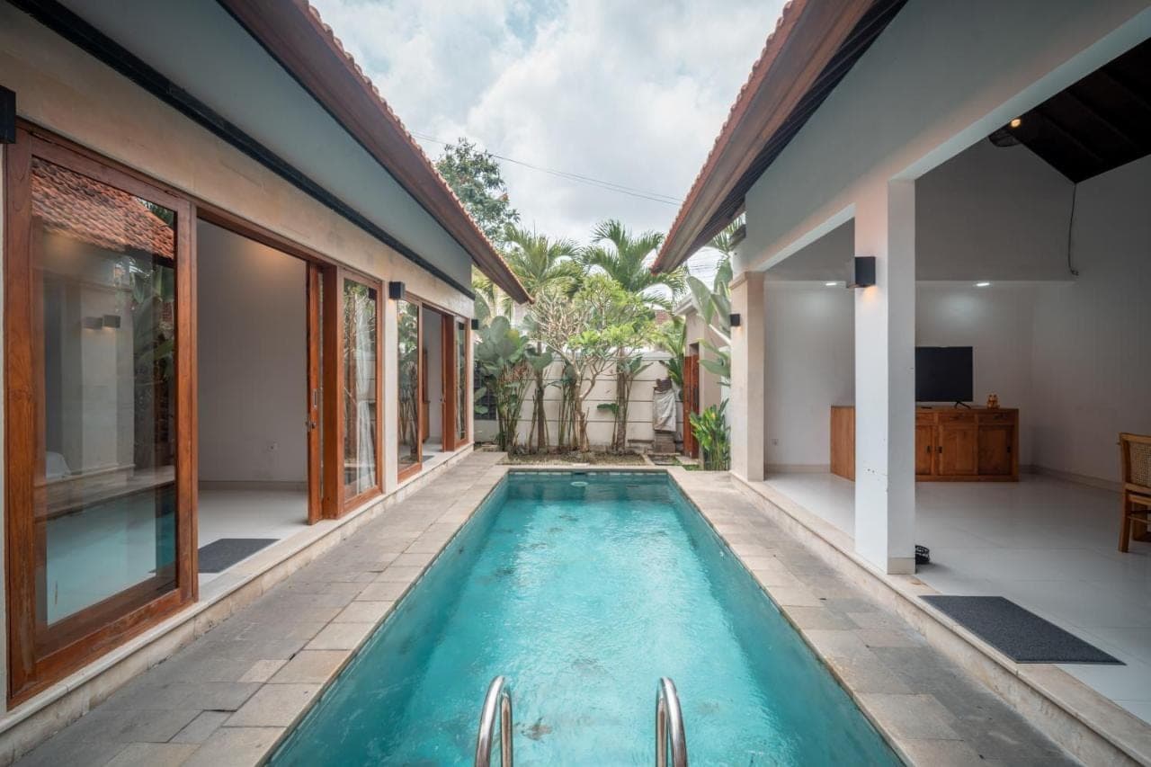a swimming pool in the backyard of a house at River Temple at Andong in Ubud