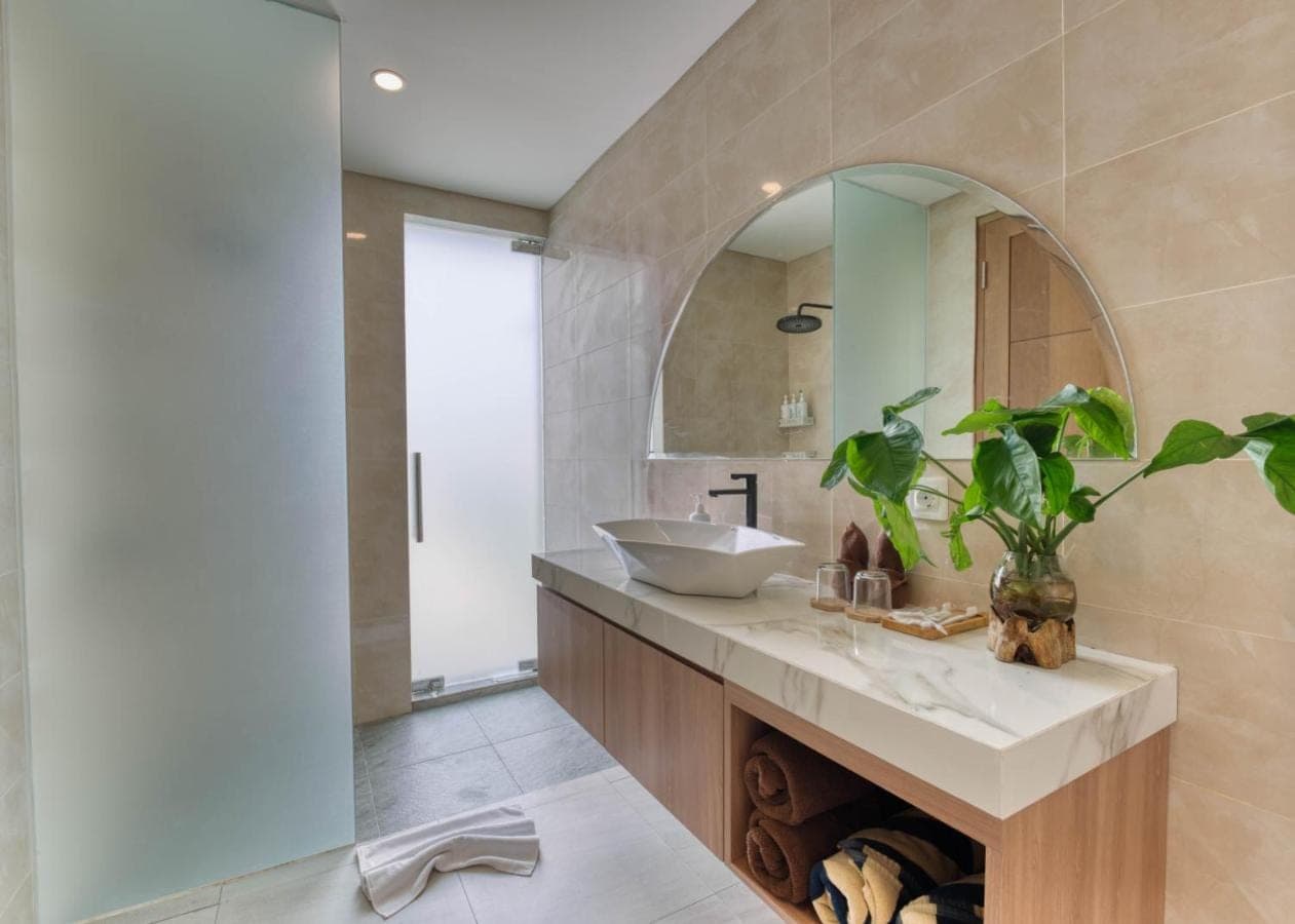 a bathroom with a sink and a mirror at Narayuka private villa Seminyak in Seminyak