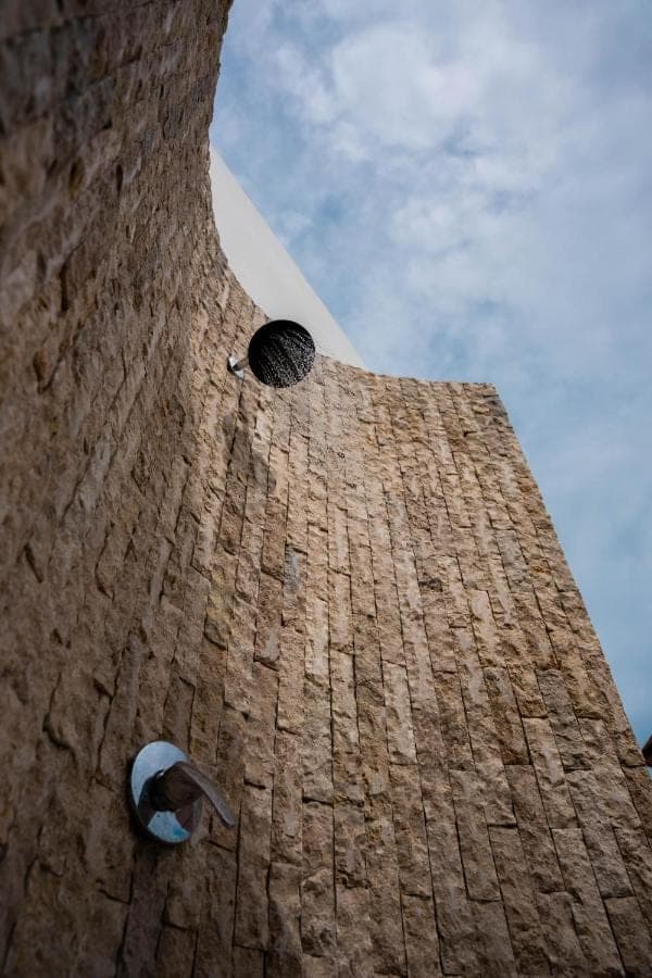 a tall brick tower with two windows on it at Narayuka private villa Seminyak in Seminyak