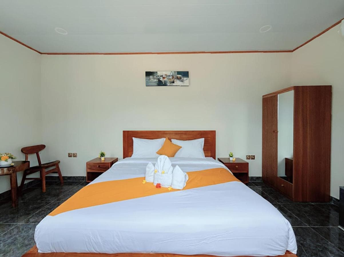 a bedroom with a large bed with two towels on it at Kotoa Villa 68 in Nusa Dua