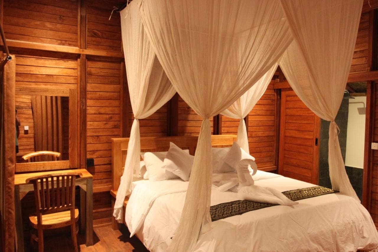 a bedroom with a bed with mosquito netting at Manuk Dewata Villa in Sidemen
