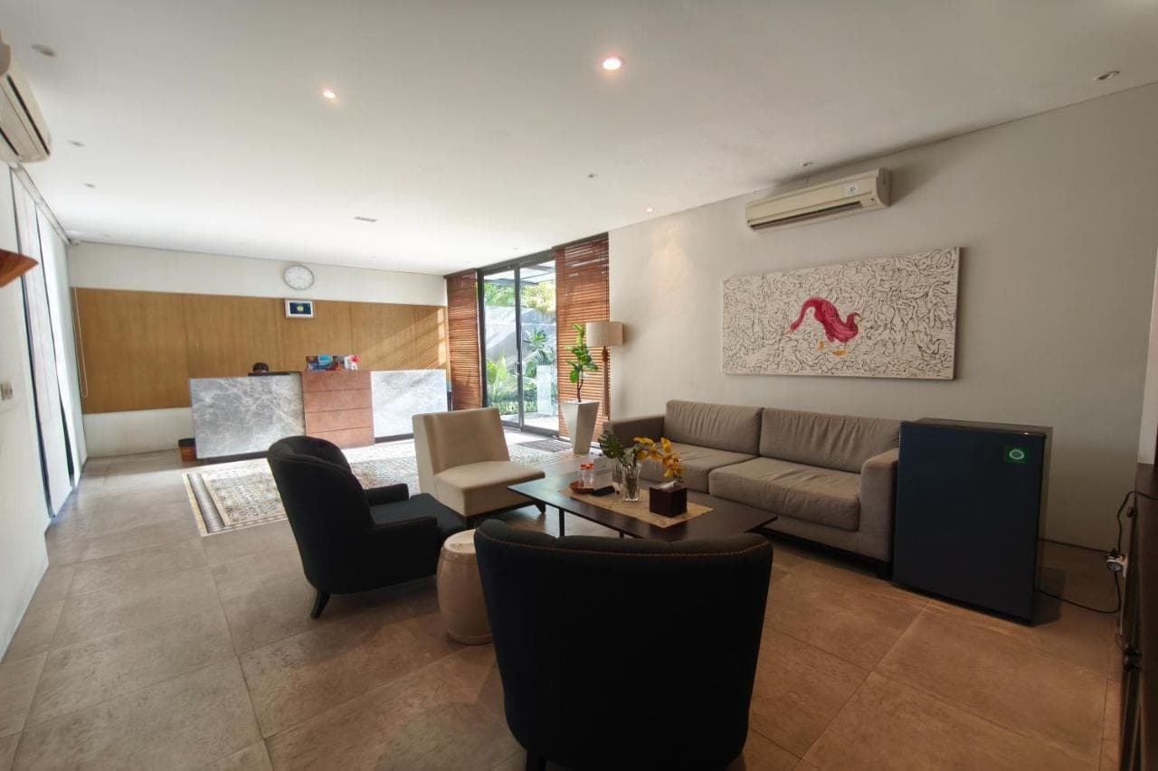 a living room with a couch and a table at Nivasa Hotel in Nusa Dua