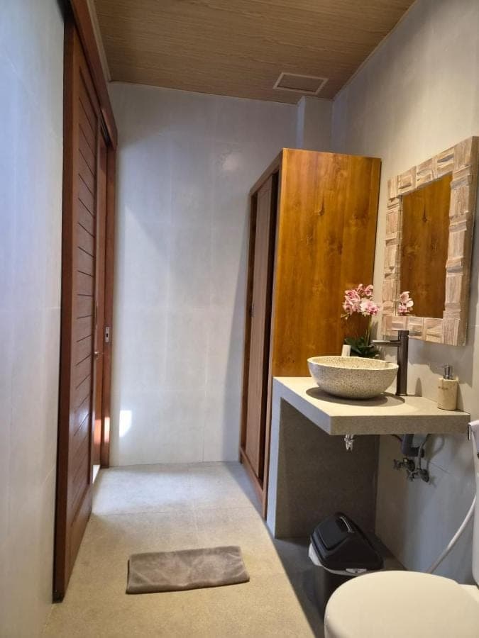 a bathroom with a sink and a bowl on a counter at Lavana Ubud in Ubud