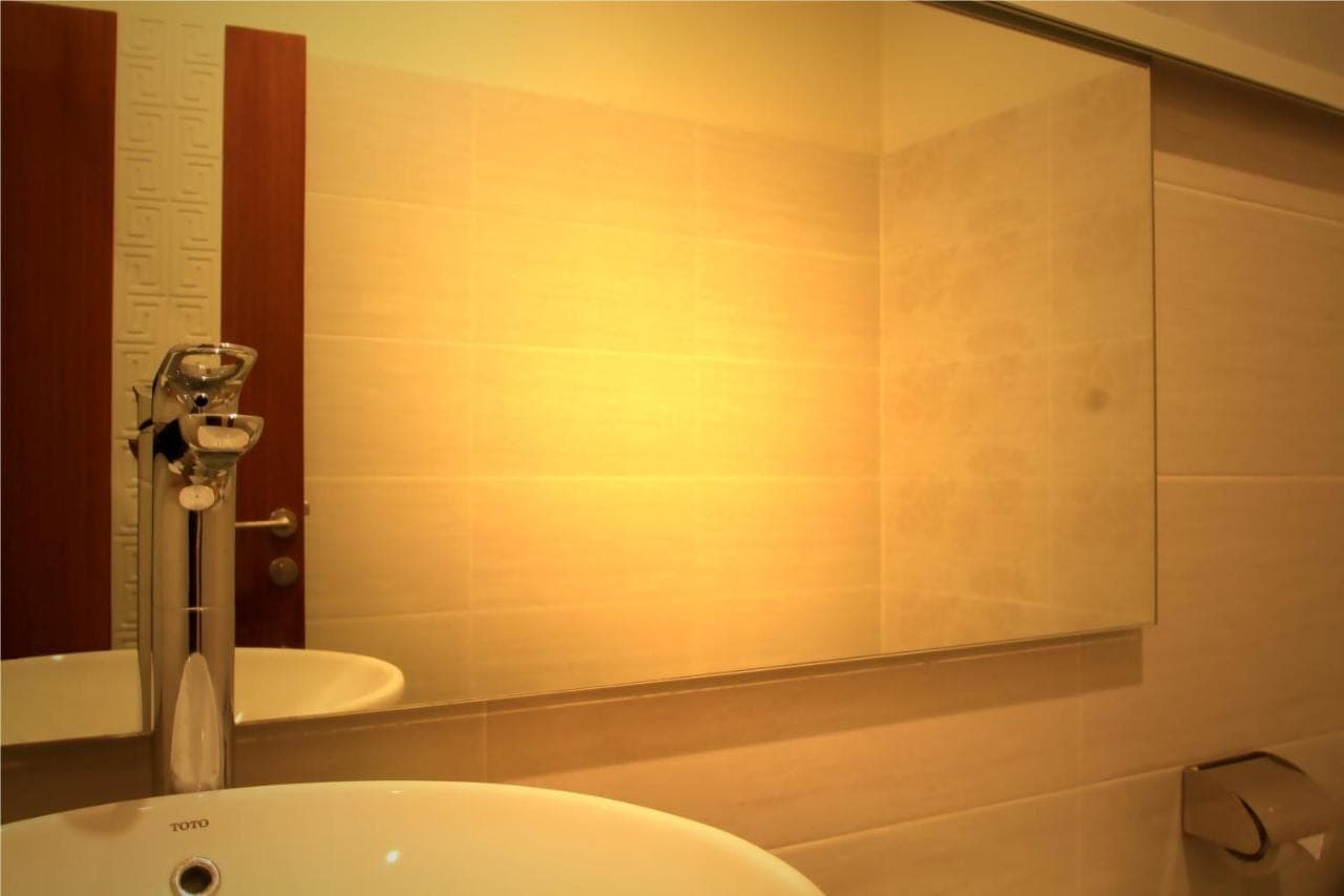 a bathroom with a white toilet and a sink at Jesens Inn II in Kuta