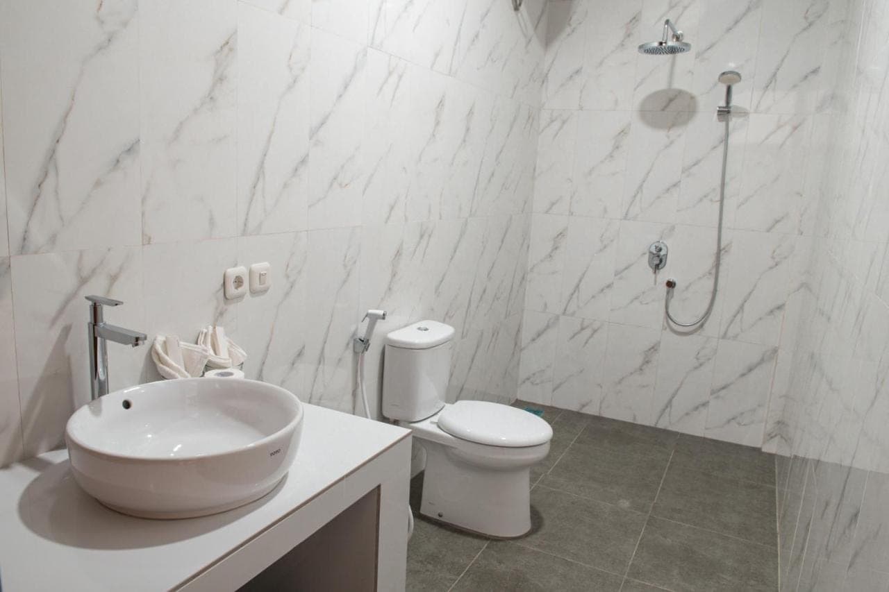 a bathroom with a sink and a toilet and a shower at Siboghana retreat in Ubud