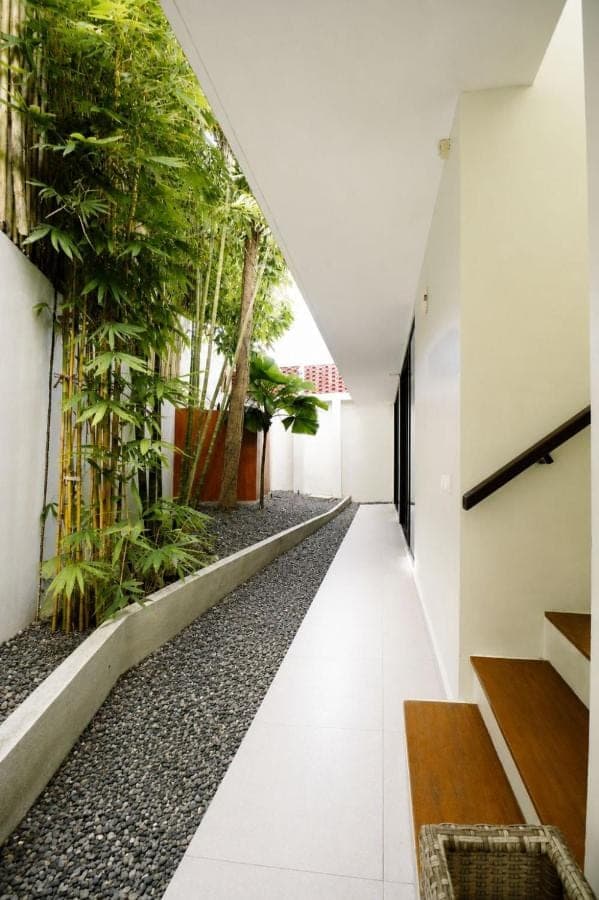 an empty hallway with plants on the wall at Mono Villa - Nusa Dua in Nusa Dua