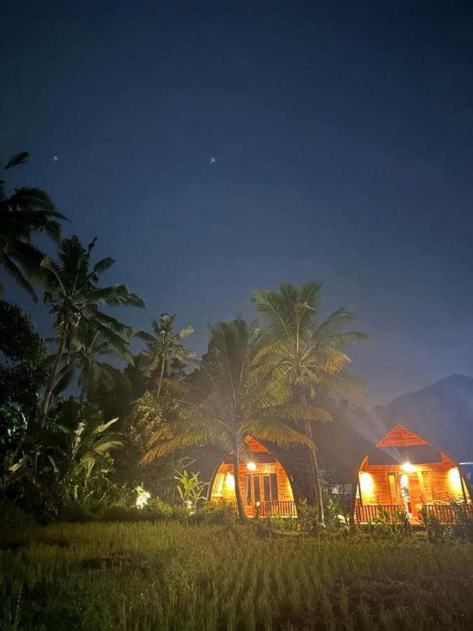 a couple of tents in a field at night at Bien dormir house in Sidemen