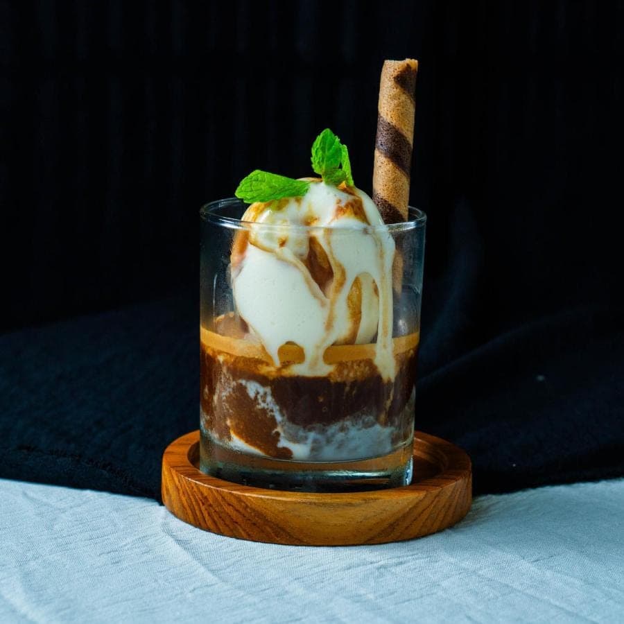 a drink with ice cream and a stick in it at Green D'mel Bali in Nusa Dua