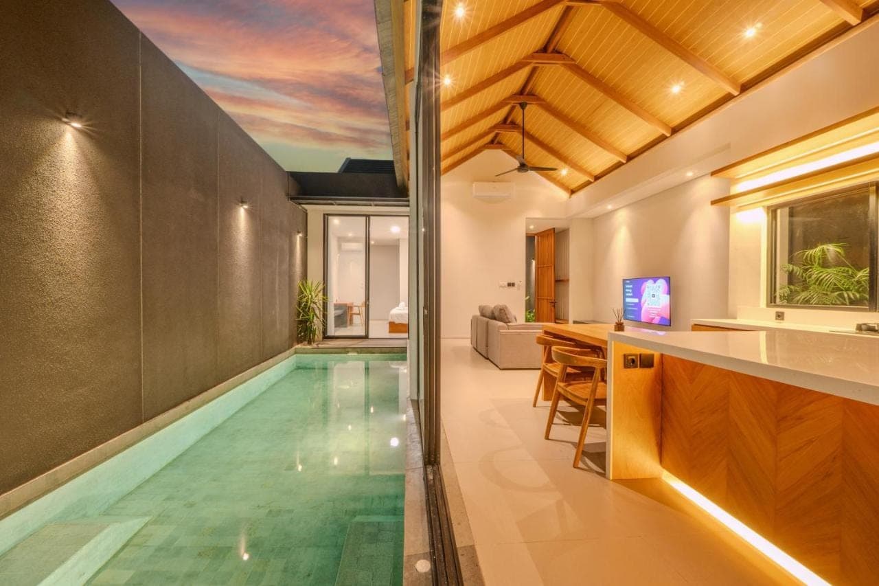 an infinity pool in the middle of a house at Tana Villa by UMAH - 2 Bedroom Villa and Private Pool Sanur in Sanur