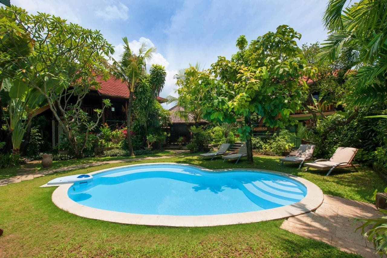 a swimming pool in the yard of a house at Pondok Agung Bed &amp; Breakfast in Nusa Dua