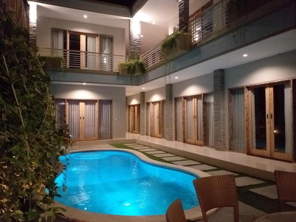 a swimming pool in the middle of a building at Rusty Seminyak in Seminyak
