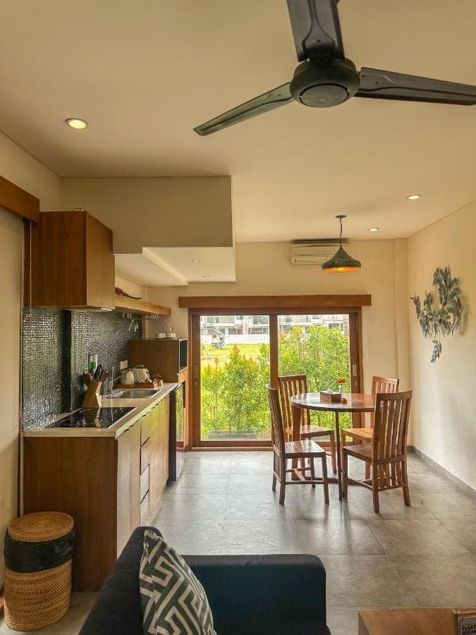 a kitchen and dining room with a table and chairs at The Wina Villa Seminyak, Near Potato Head Beach Club in Seminyak