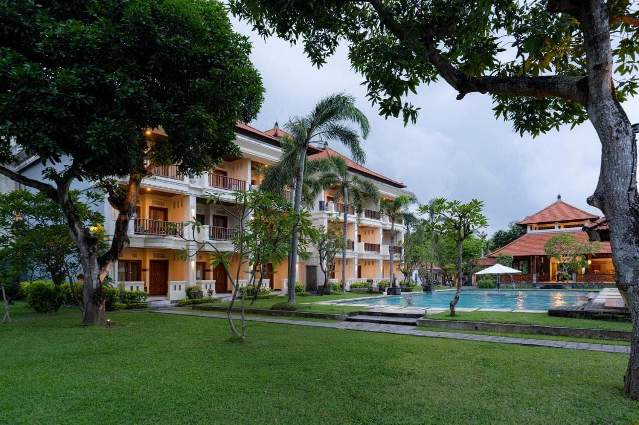 a resort with a swimming pool and trees at Kusuma Resort Seminyak in Seminyak