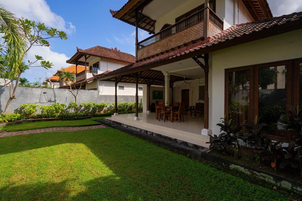 a house with a lawn in front of it at Kusuma Resort Seminyak in Seminyak