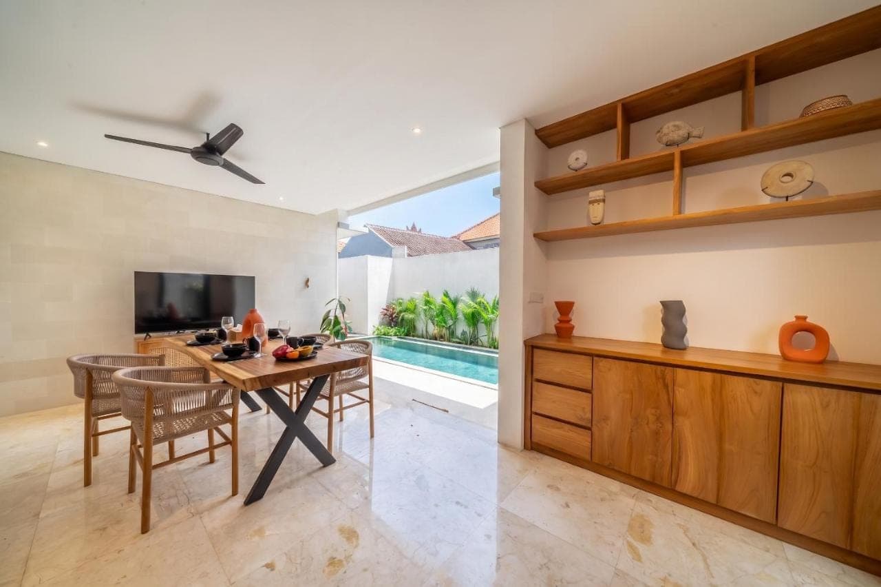 a kitchen and dining room with a table and chairs at Lekatika - Spacious Pool Villa Close to Local Hotspots in Seminyak