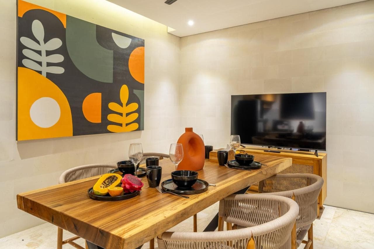 a dining room with a wooden table and chairs at Lekatika - Spacious Pool Villa Close to Local Hotspots in Seminyak