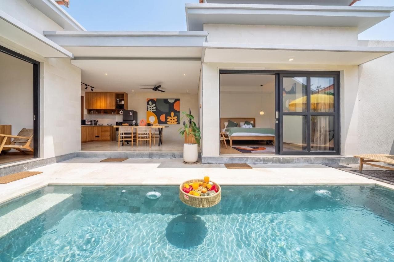 a villa with a swimming pool with a bowl of fruit at Lekatika - Spacious Pool Villa Close to Local Hotspots in Seminyak