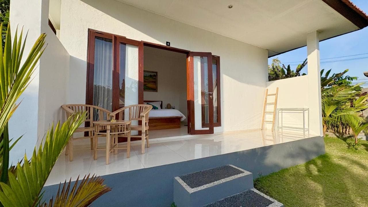 a guest house with a balcony with a bedroom at ANANDA Bingin Guesthouse in Uluwatu
