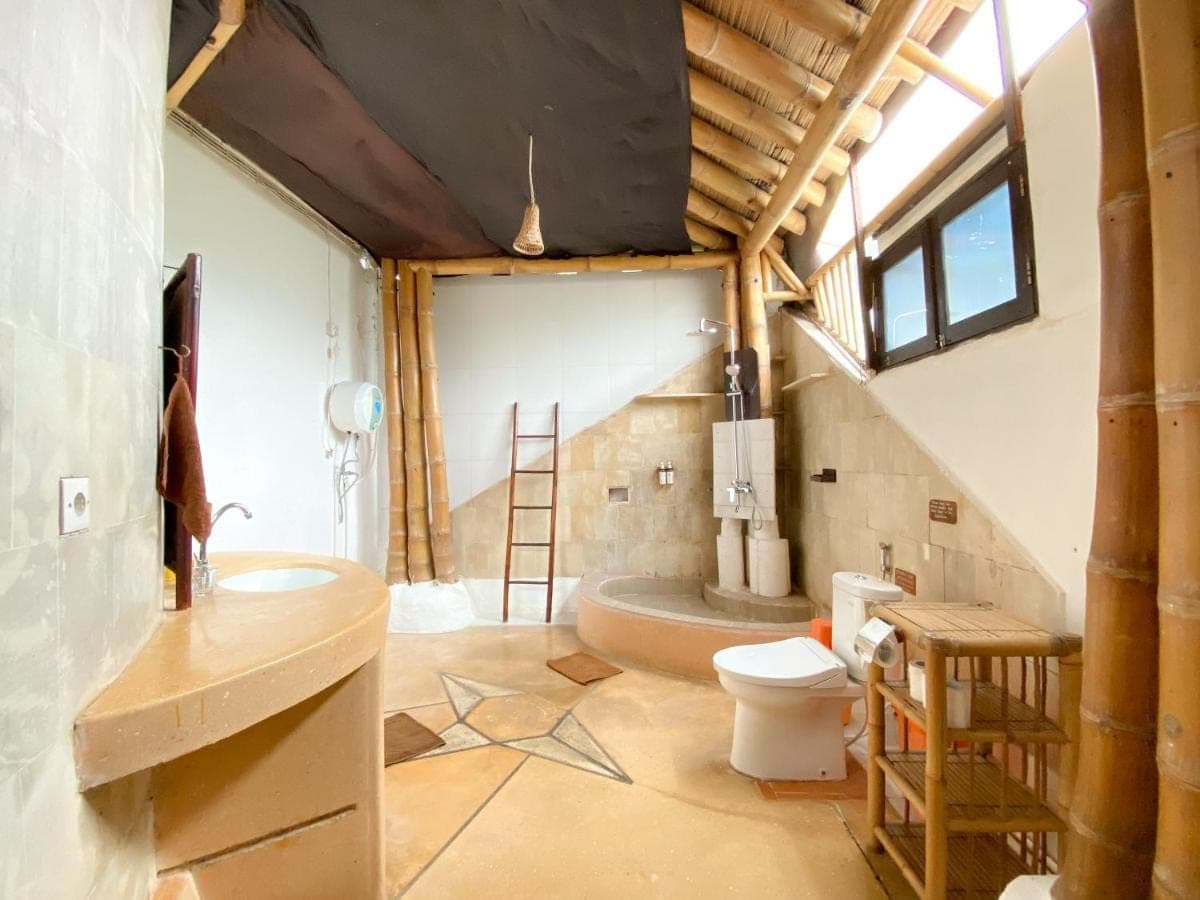 a bathroom with a toilet and a sink at Serenity Eco Guesthouse and Yoga- CHSE certified in Canggu