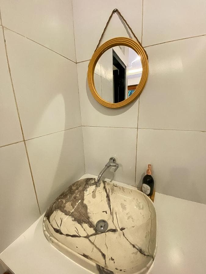 a sink in a bathroom with a mirror at Malaka pedati homestay in Uluwatu