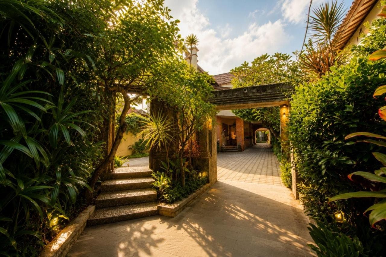 an entrance to a house with plants and stairs at Bali Ayu Hotel & Villas 10 Minutes Walking Distance to the Beach in Seminyak