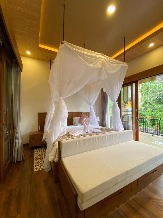 a bedroom with a bed with a canopy at Sunya Giri Lodge & Retreat in Sidemen