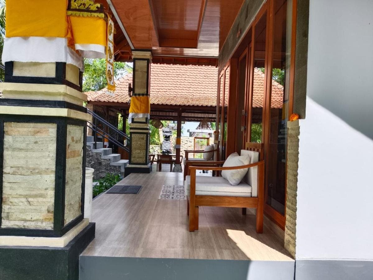 a porch of a house with a chair and stairs at Sunya Giri Lodge & Retreat in Sidemen