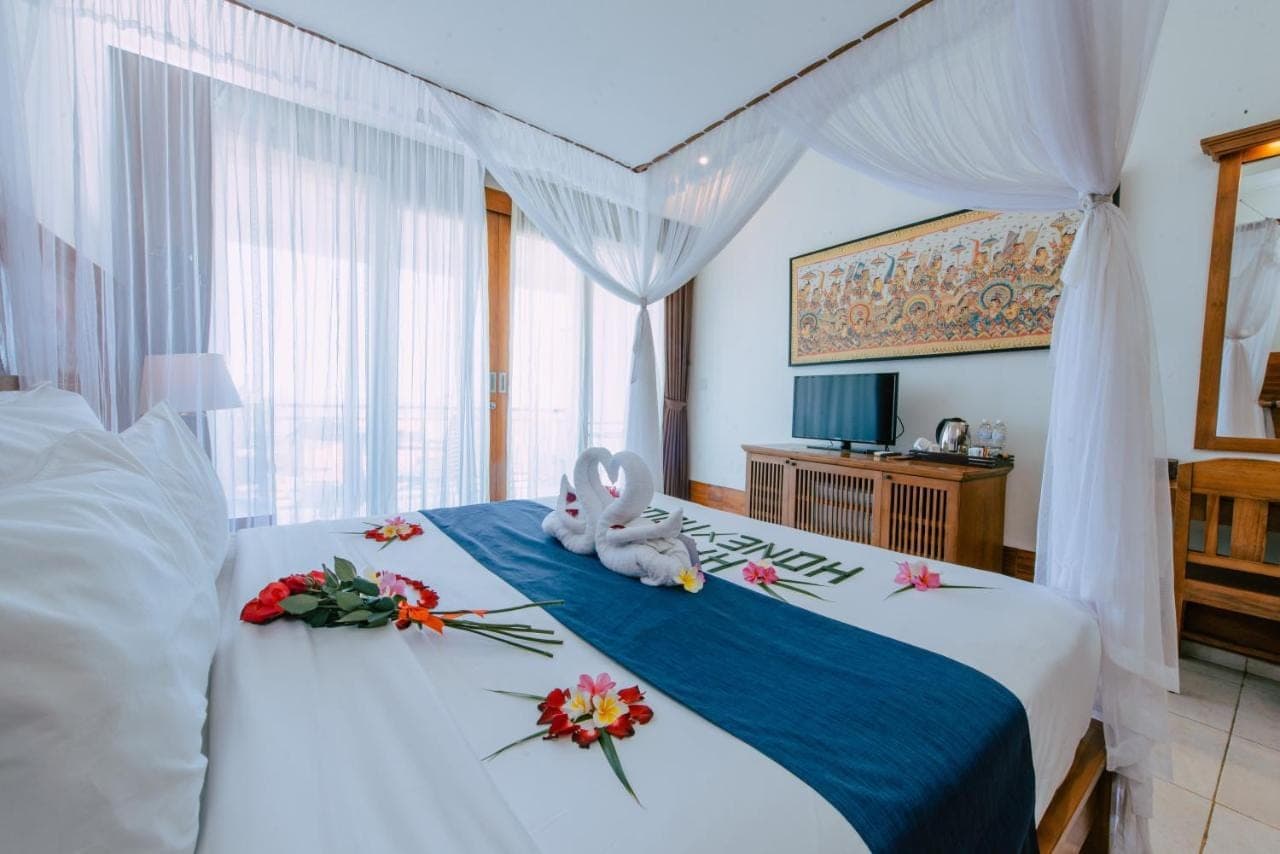 a bedroom with a bed with a stuffed bunny on it at Puri Pandawa Resort in Nusa Dua