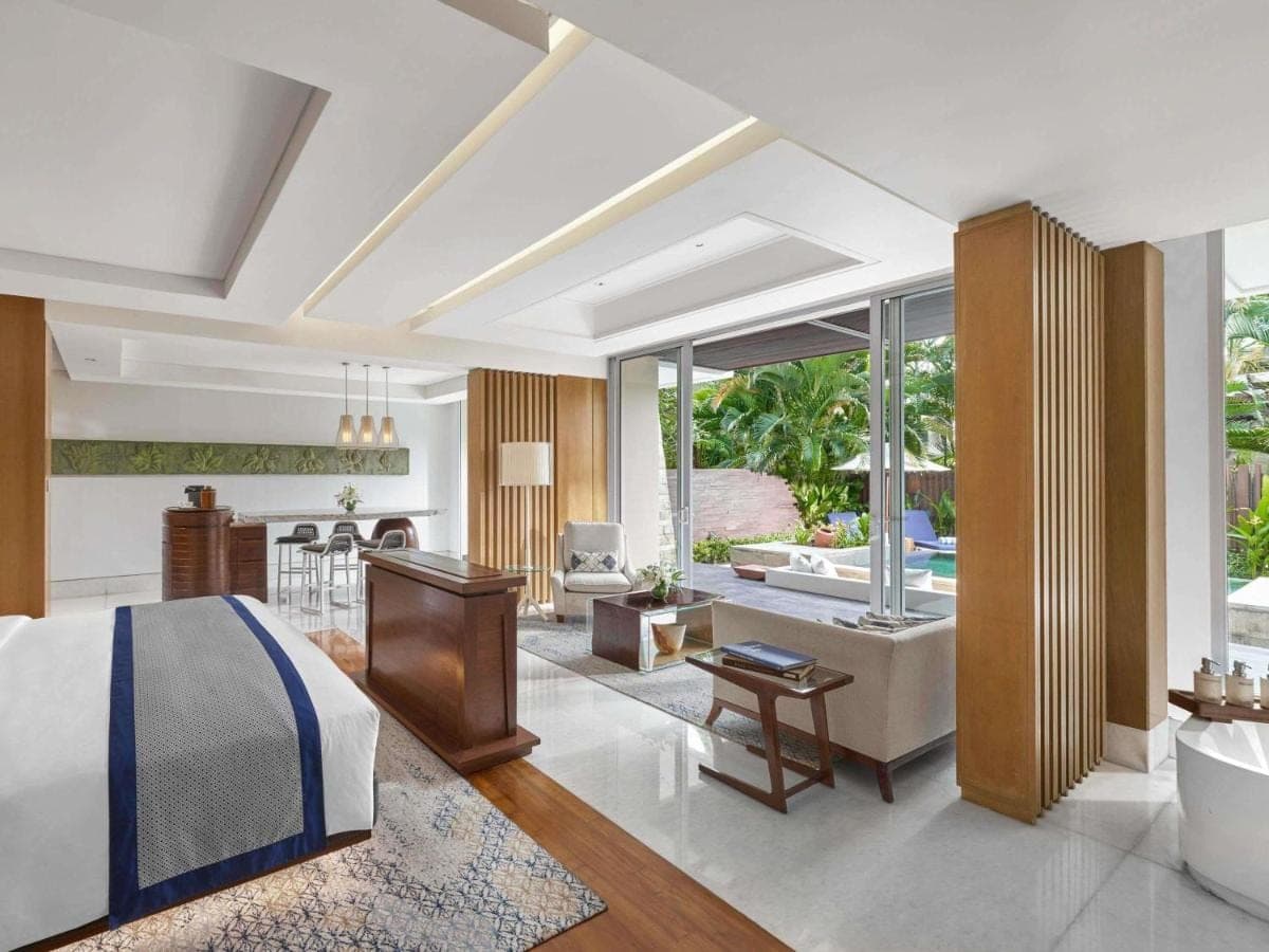 a bedroom with a bed and a living room at Sofitel Bali Nusa Dua Beach Resort in Nusa Dua