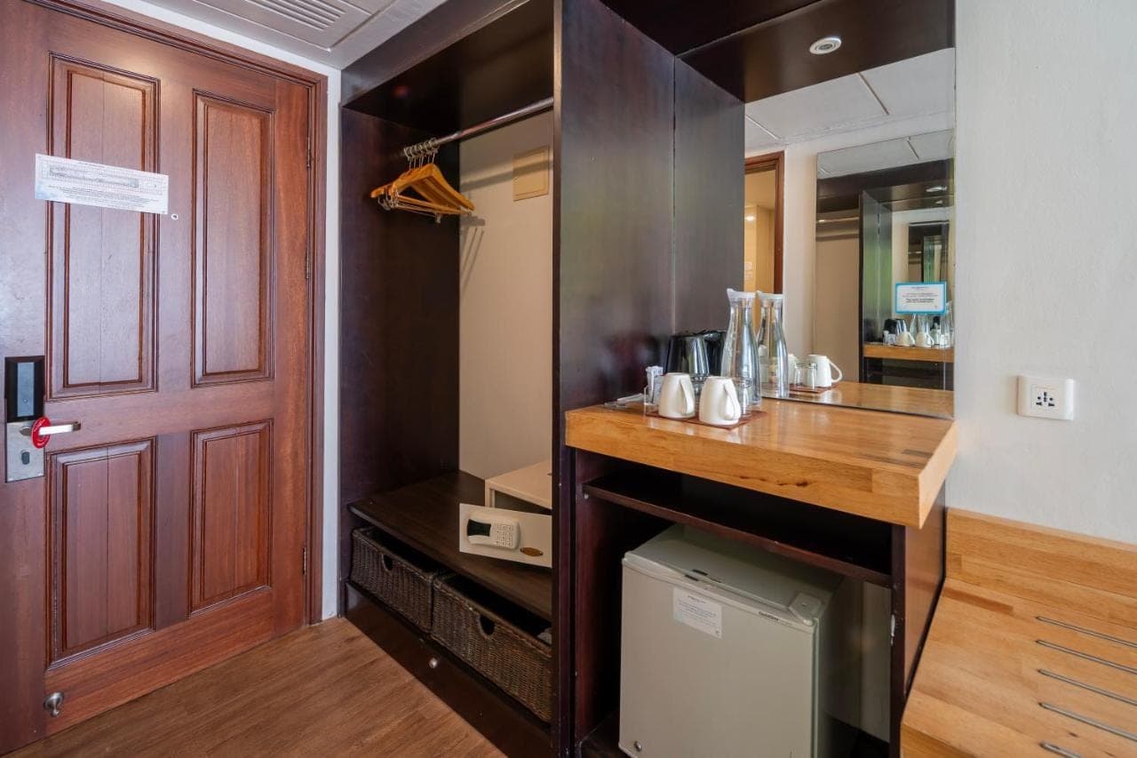 a room with a kitchen with a counter and a door at Prime Plaza Hotel Sanur \u2013 Bali in Sanur
