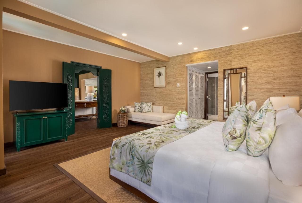 a large bedroom with a large bed and a television at Prime Plaza Hotel Sanur \u2013 Bali in Sanur
