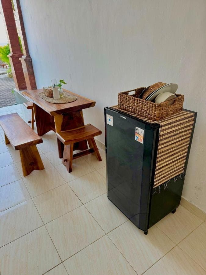 a room with a table and a small table with a basket at South Hill Pandawa in Nusa Dua