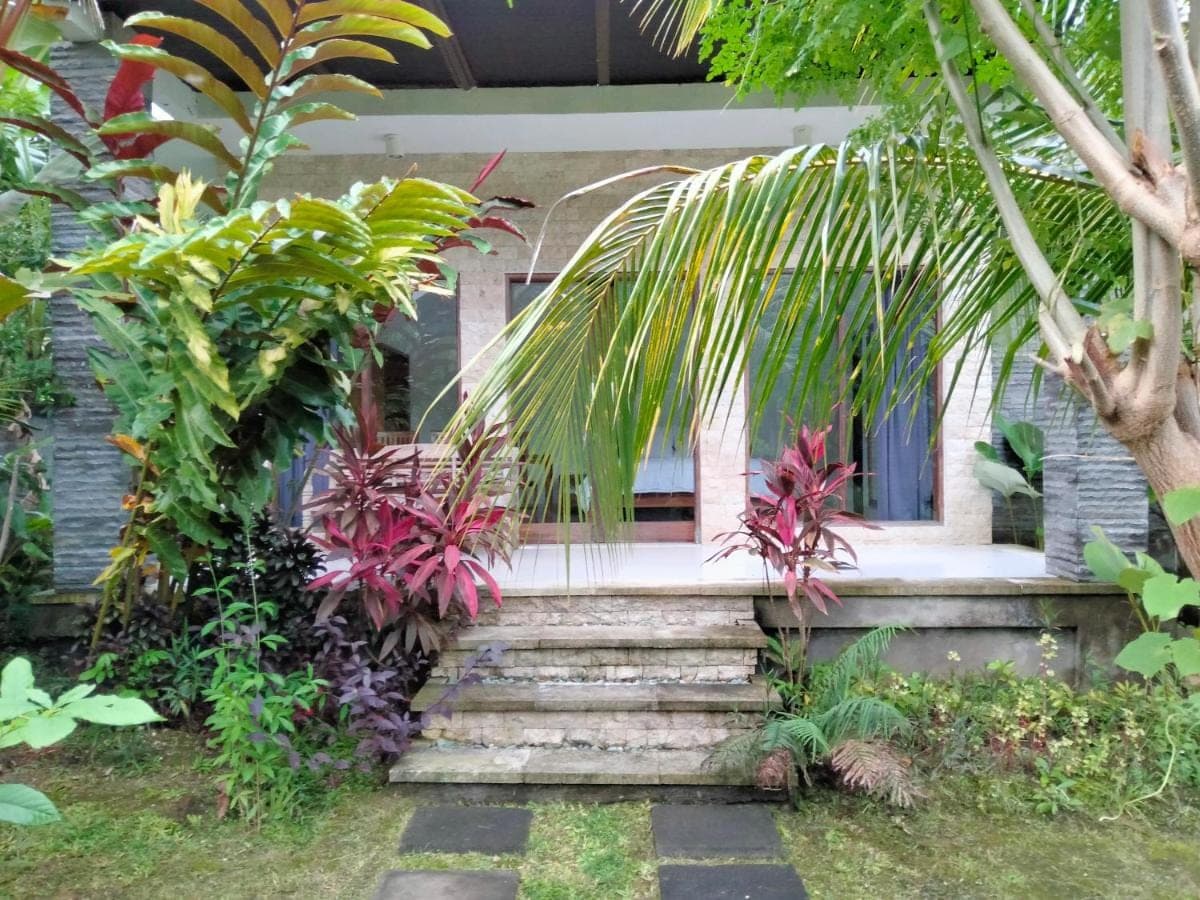 a stairway leading to a house with plants at Pier26 Bali Homestay in Nusa Dua