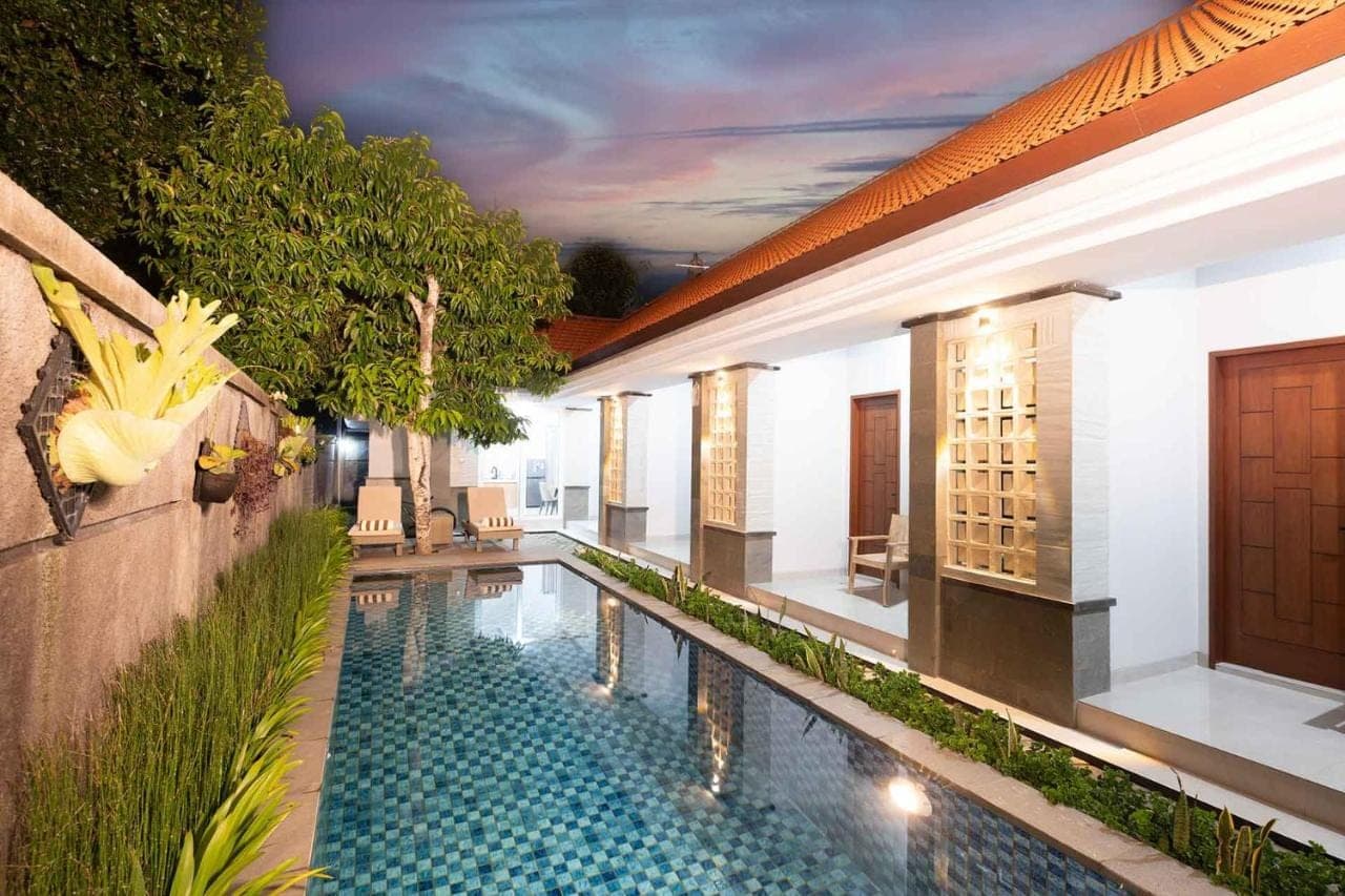a swimming pool in the middle of a building at Kemala Living Sanur in Sanur
