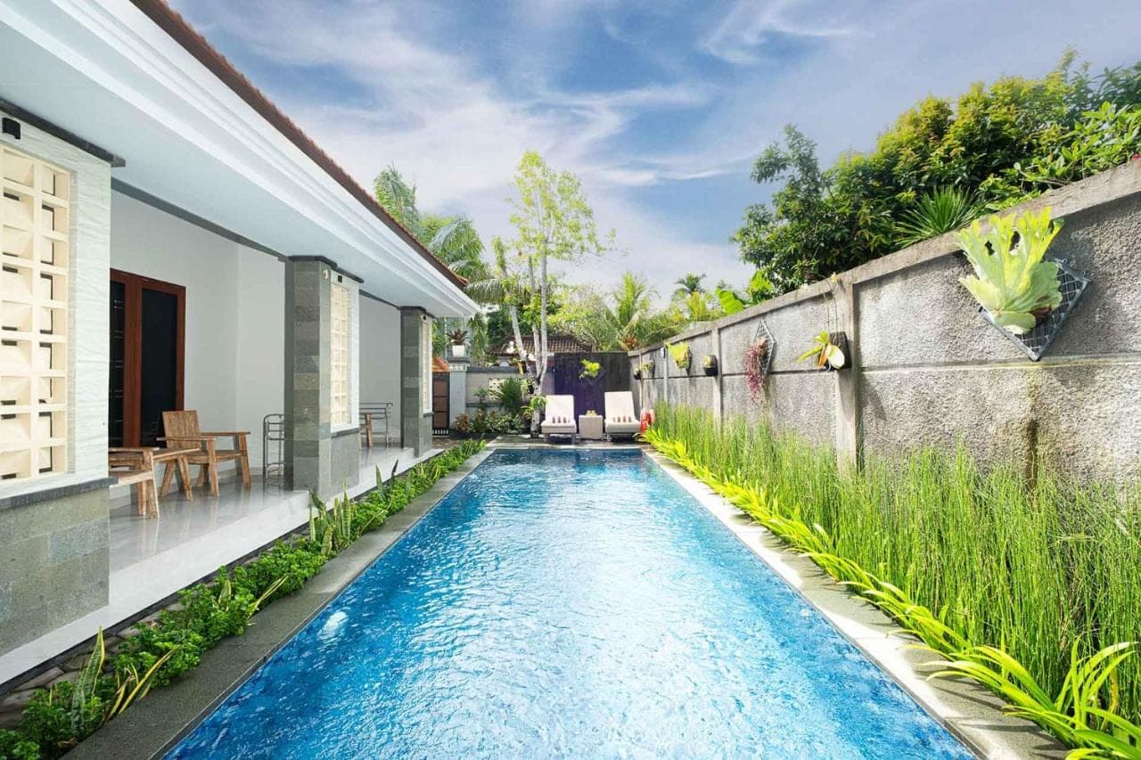 a swimming pool in the backyard of a house at Kemala Living Sanur in Sanur