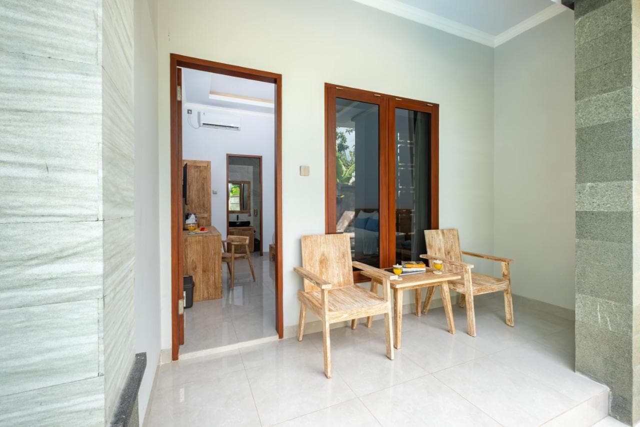 a dining room with a table and two chairs at Kemala Living Sanur in Sanur