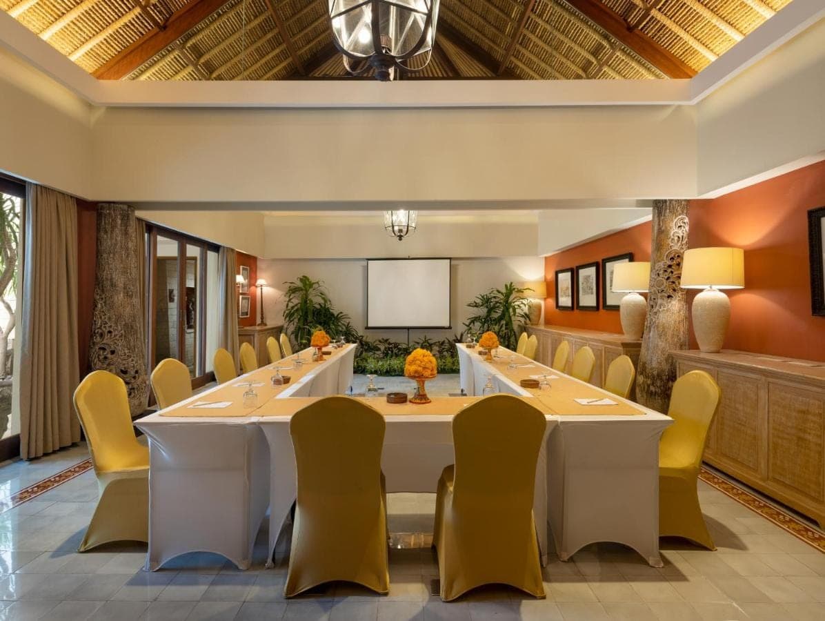 a conference room with a large table and chairs at Sudamala Resort, Sanur, Bali in Sanur