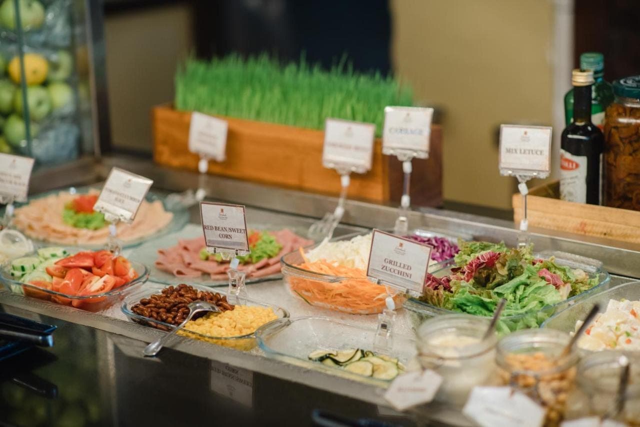 a buffet with many different types of food on display at Ramayana Suites and Resort in Kuta