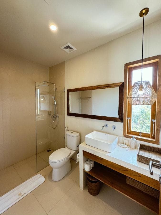 a bathroom with a toilet and a sink and a shower at Villa Indah Rose Canggu Bali in Canggu