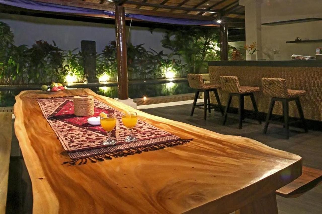 a table with two glasses of orange juice on it at Linda Villa Sanur by Linda in Sanur