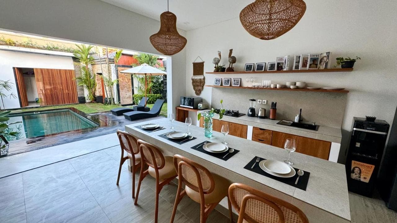 a kitchen and dining room with a table and chairs at Villa Niu Center Canggu - FattyLion in Canggu