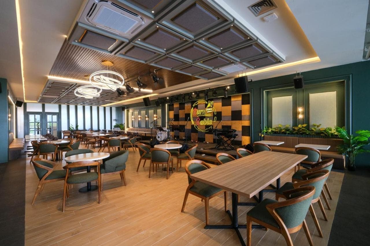 a restaurant with tables and chairs in a room at ValStar Hotel Canggu in Canggu
