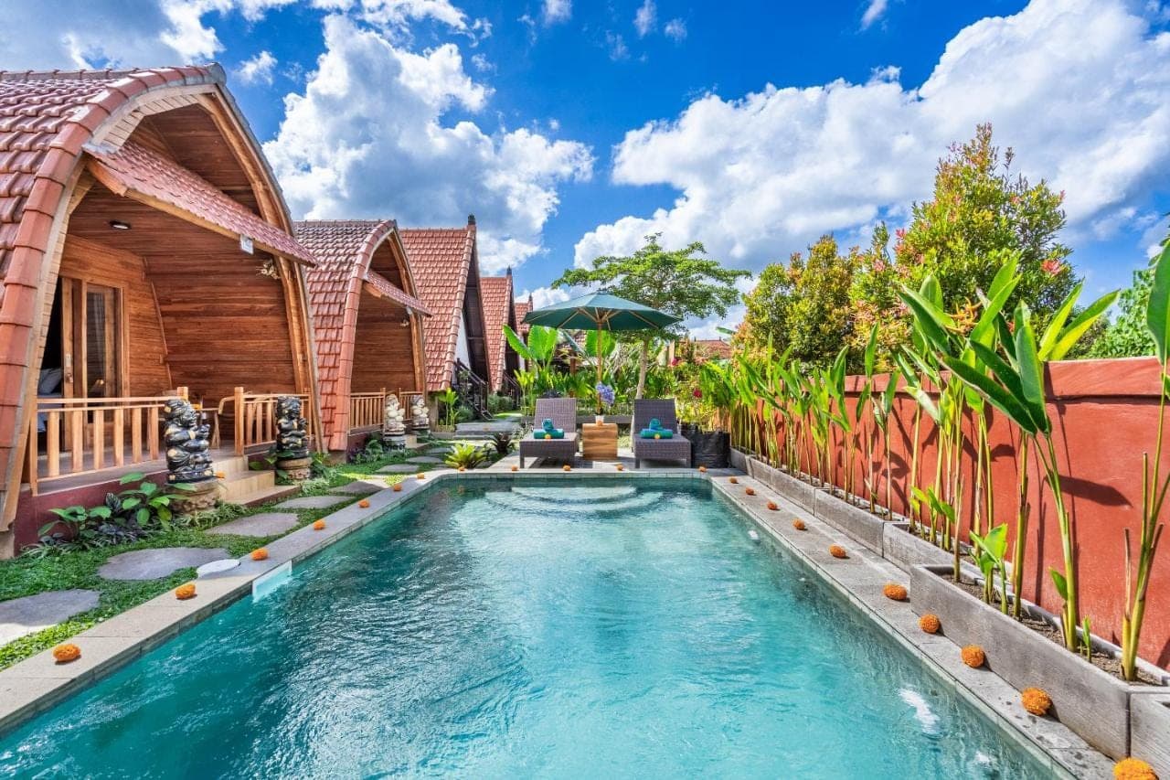 a swimming pool in the backyard of a house at Lumbung Sari villa ubud by Dewanta Property in Ubud