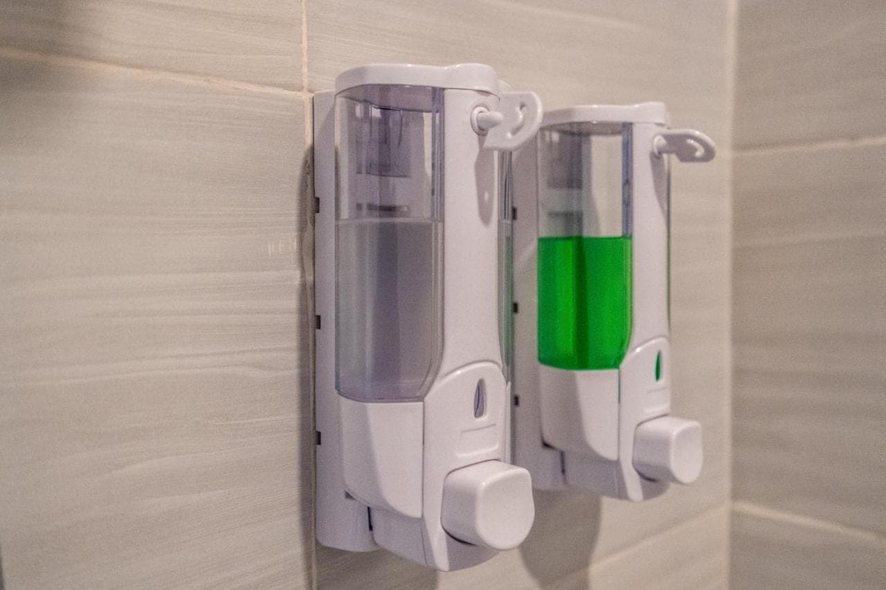 two soap dispensers are hanging on a wall at Lumbung Sari villa ubud by Dewanta Property in Ubud
