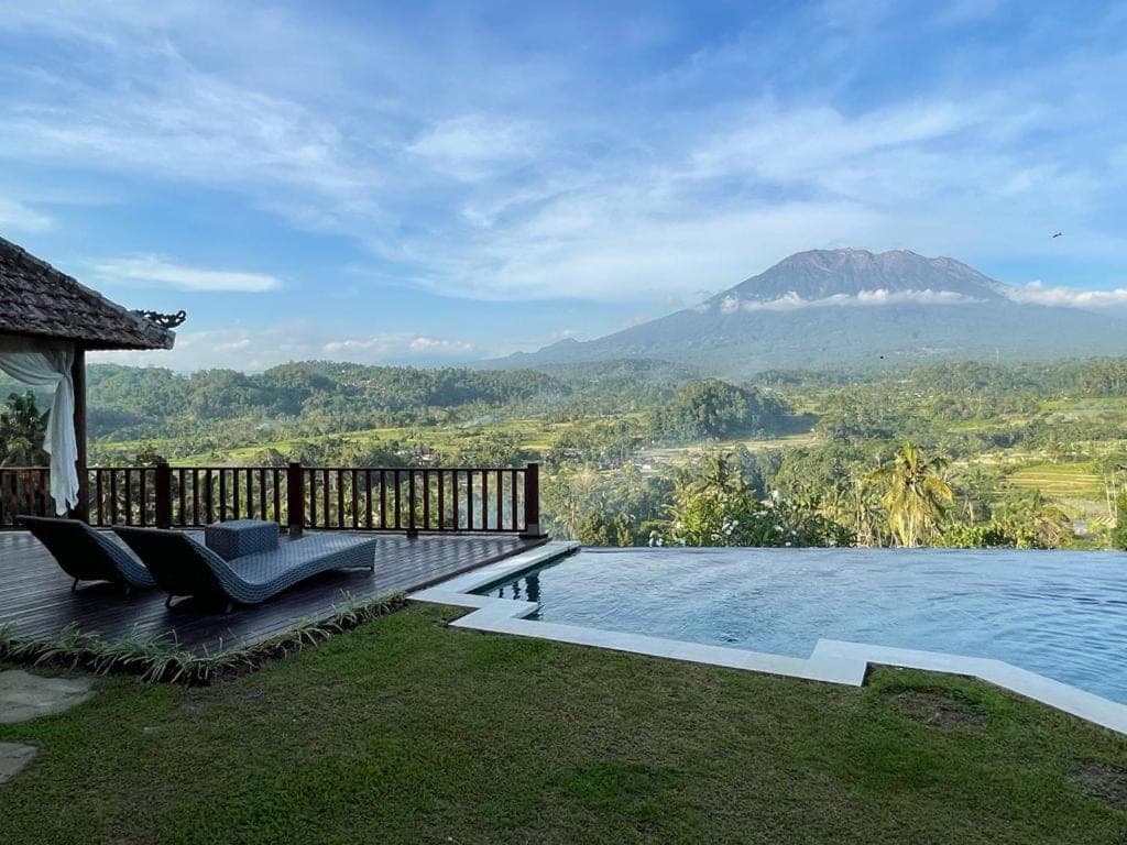 a swimming pool with a view of a mountain at Patal Kikian Villa in Sidemen