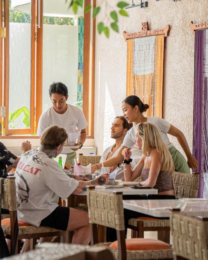 a group of people sitting at a table at Lomo Boutique Hotel & Villas, Uluwatu in Uluwatu
