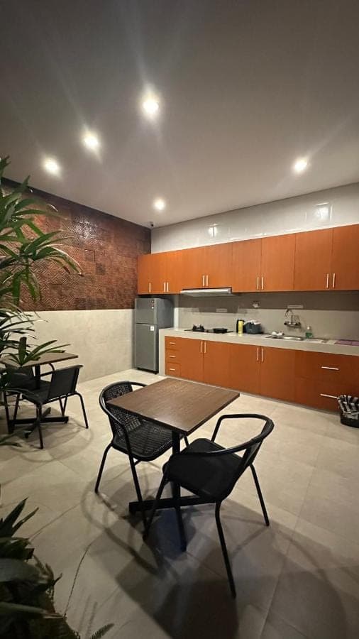 a kitchen with a table and chairs and a counter at Sekuta 36 in Sanur