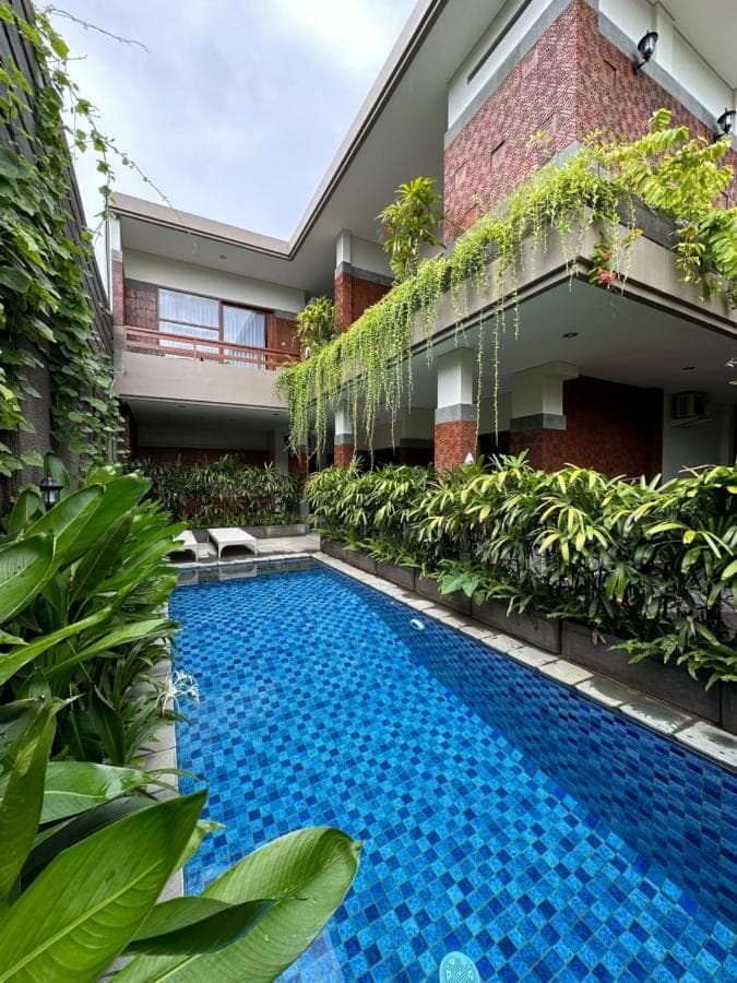 a swimming pool in front of a building at Sekuta 36 in Sanur